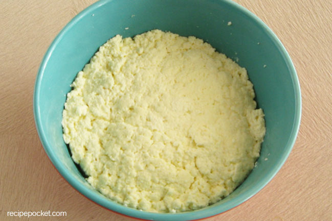 Homemade ricotta cheese in a bowl.