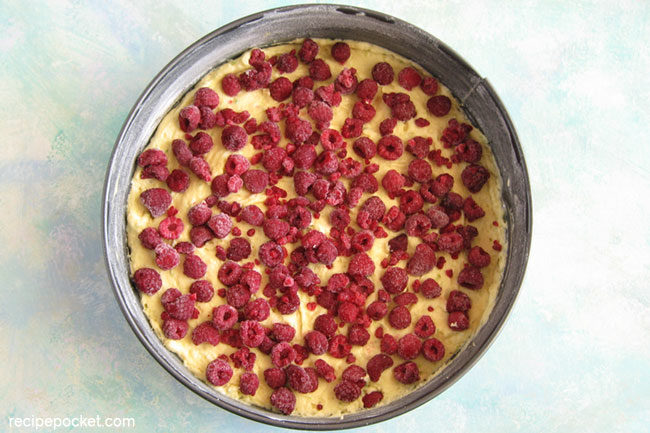 Easy raspberry Greek yogurt cake. Top the batter with frozen raspberries.