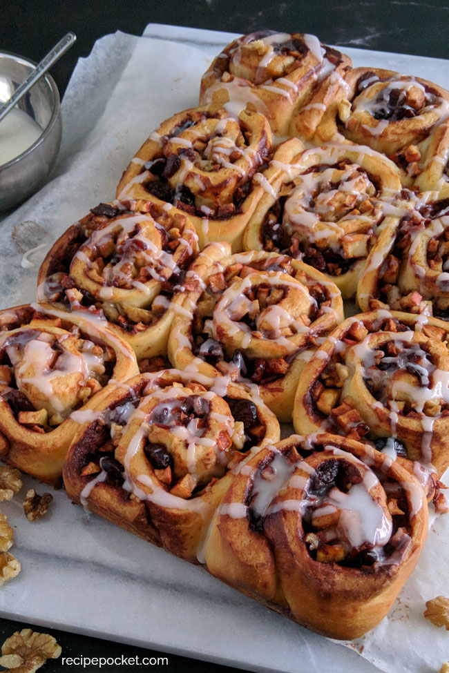 Baked apple cinnamon rolls with icing.