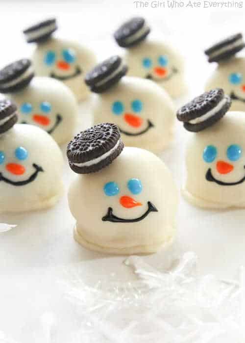 White chocolate coated oreo balls that look like snowmen.