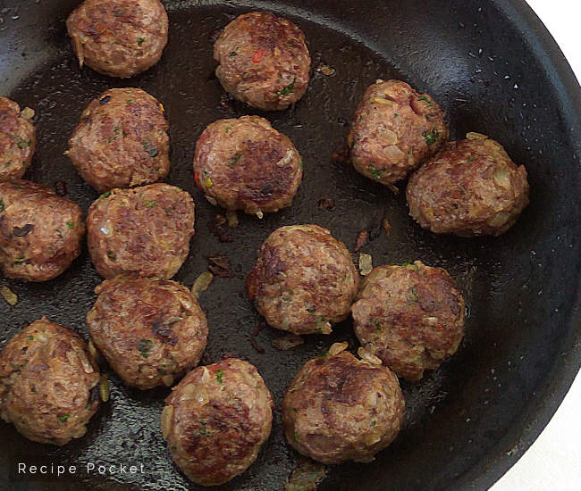Meatballs in a cast iron pan.