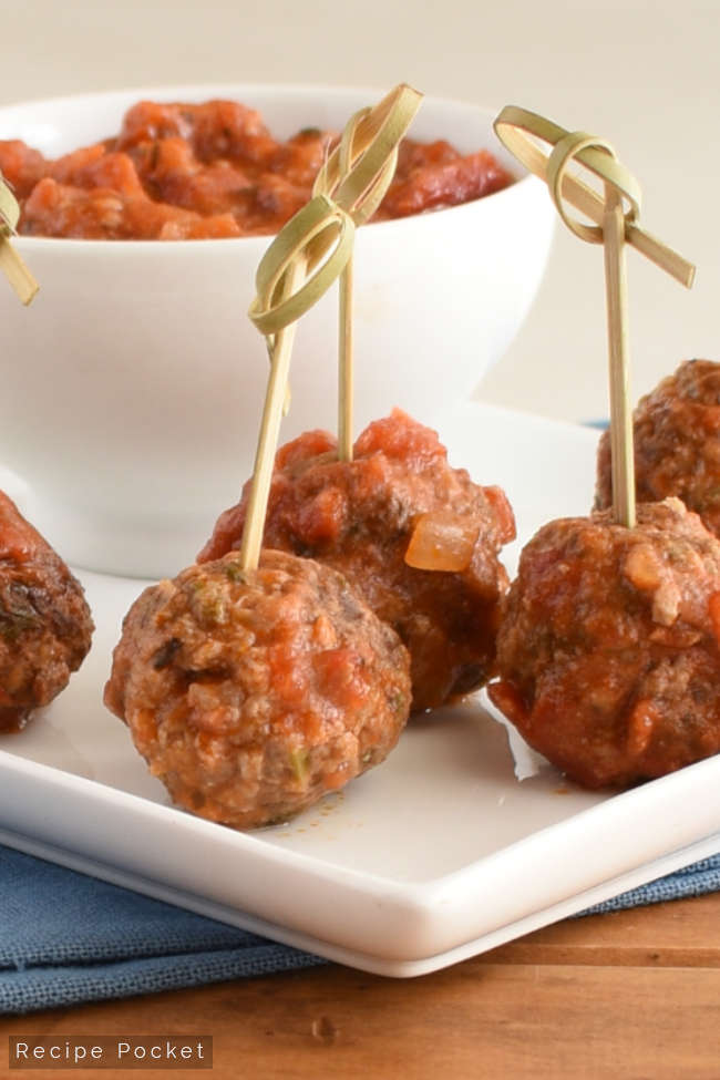 Meatballs in tomato sauce served as toothpick appetizers.