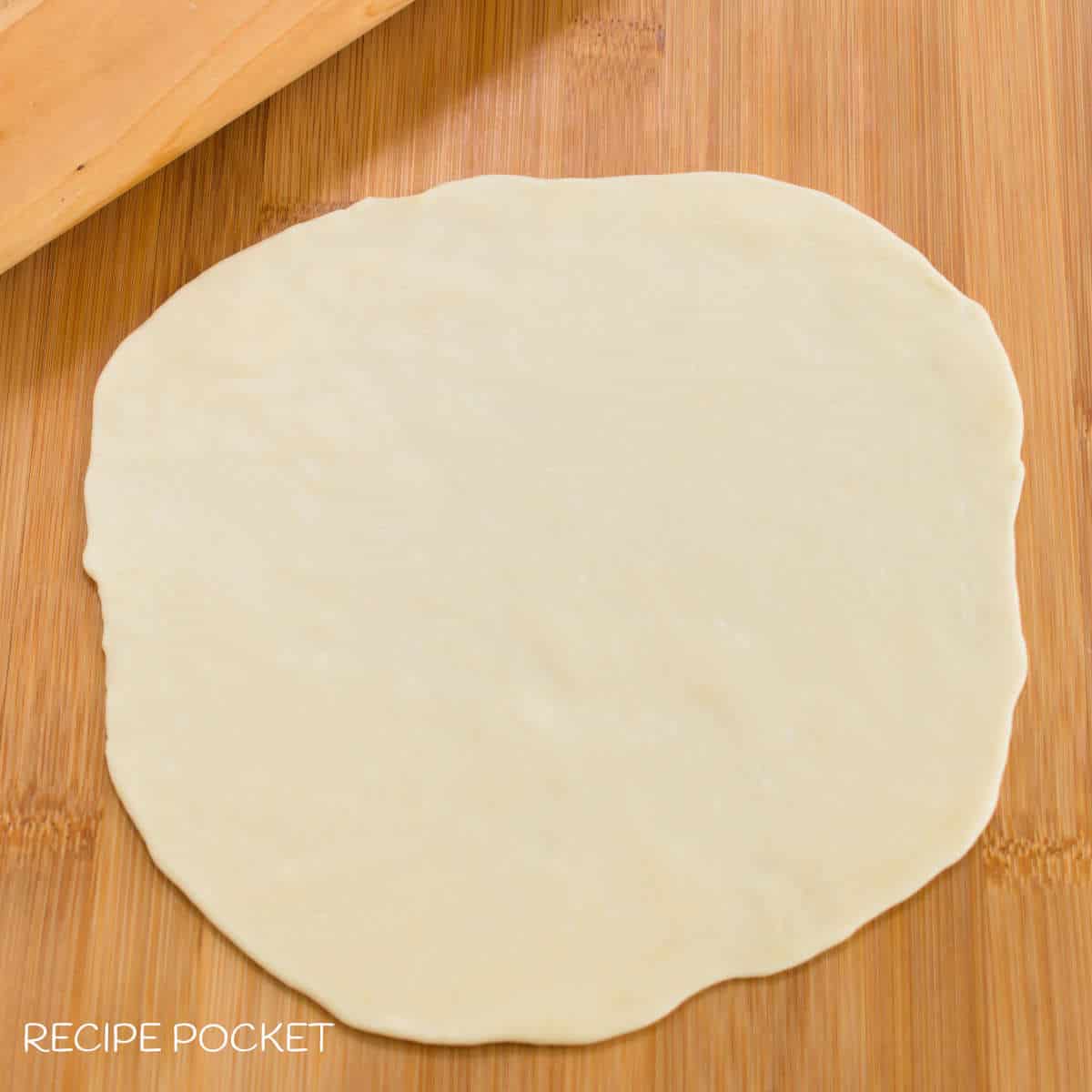 Dough rolled into a thin round shape.