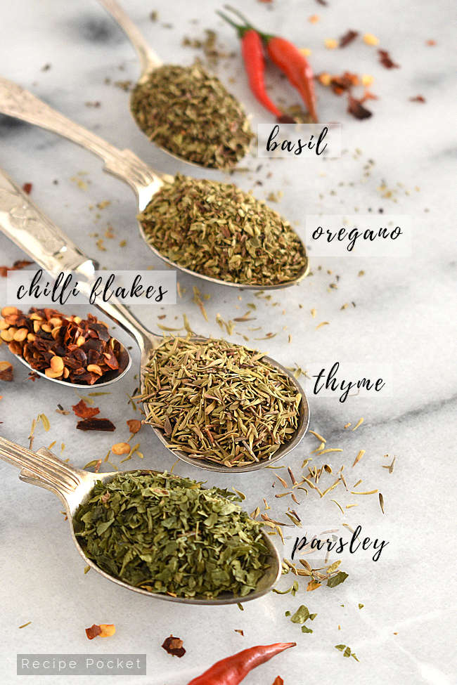 Image showing a variety of Italian dried herbs on teaspoons.