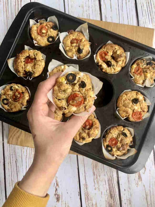 Whole wheat savoury pizza muffins in a baking tray.