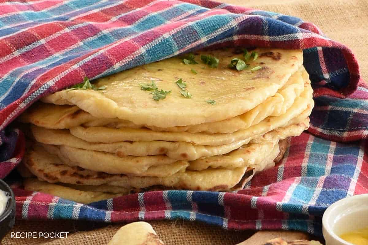 Naan bread wrapped in a tea towel.