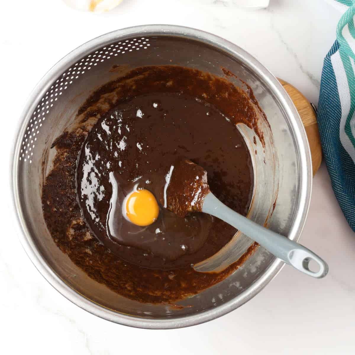 Melted chocolate and egg in a bowl.
