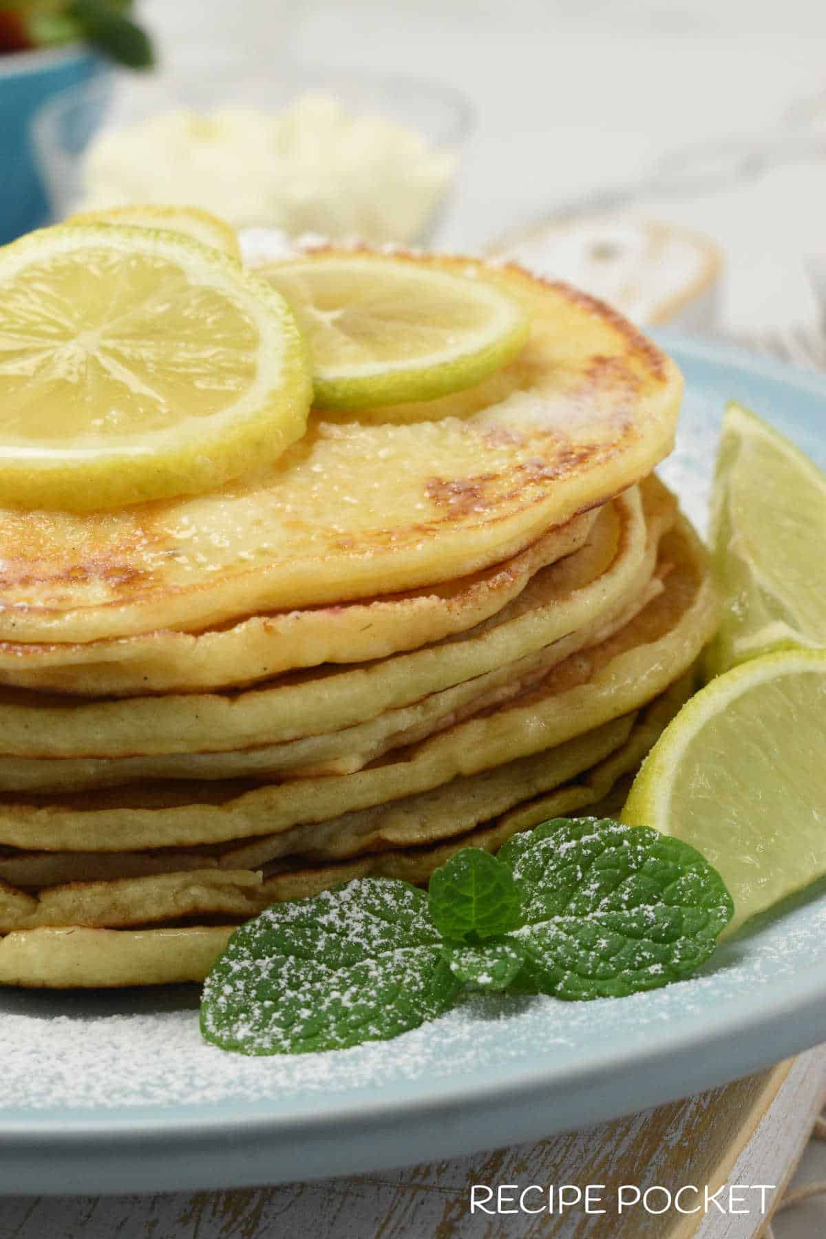 Lemon ricotta pancakes on a blue plate.