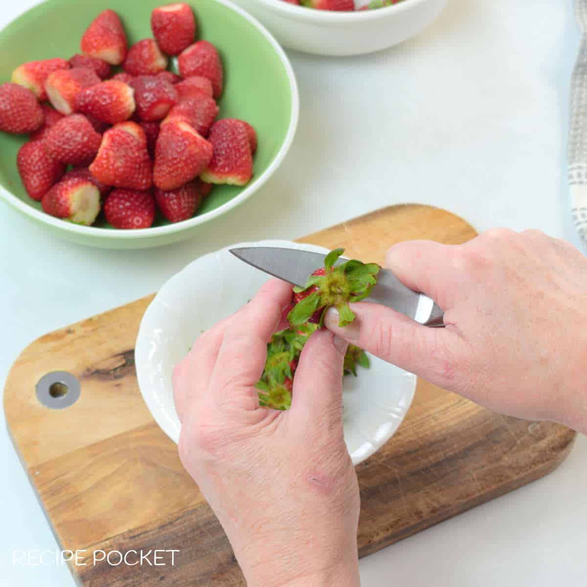 Hulling strawberries.