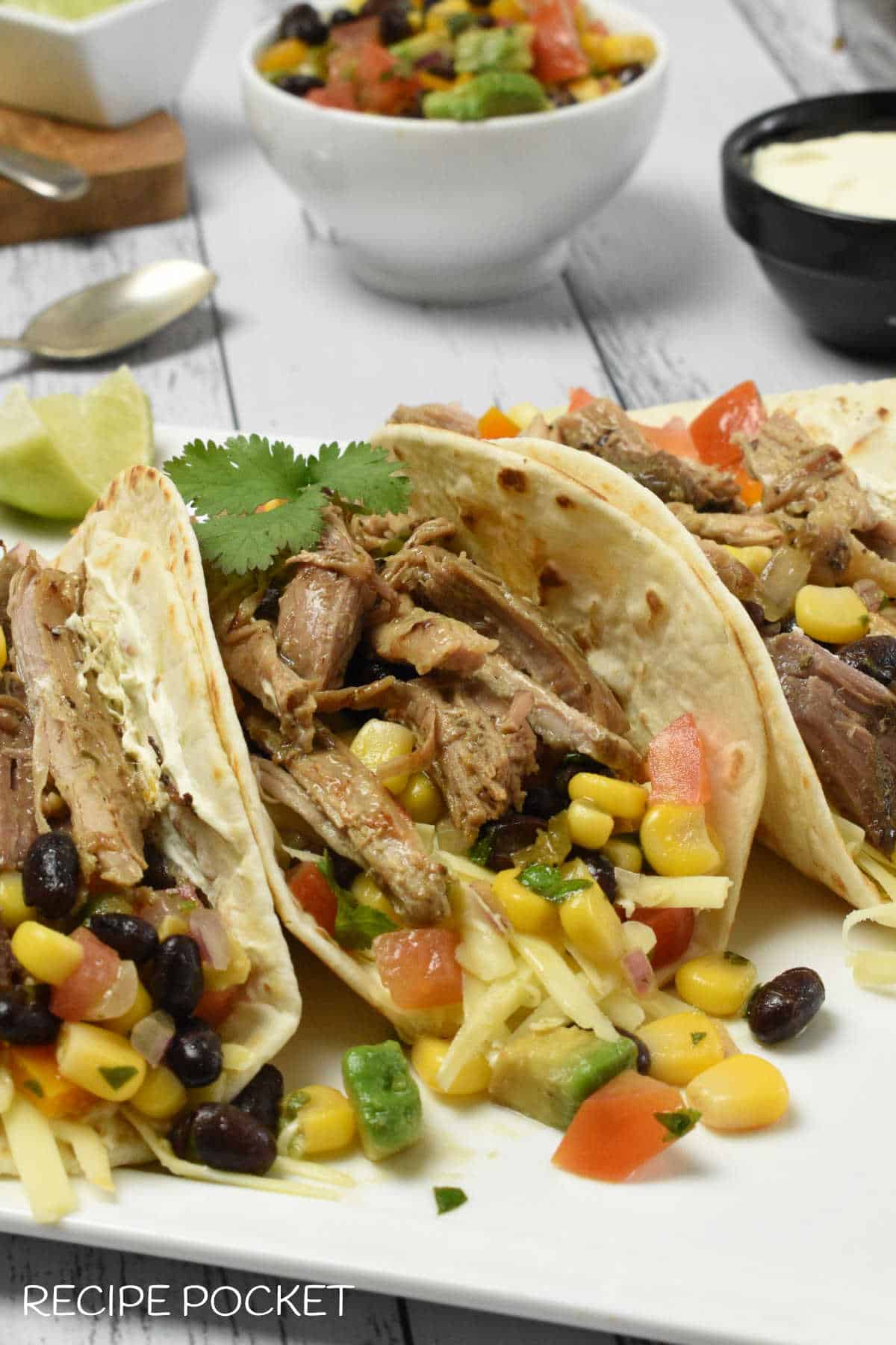 Soft shell taco with pulled pork and black bean and corn salad.