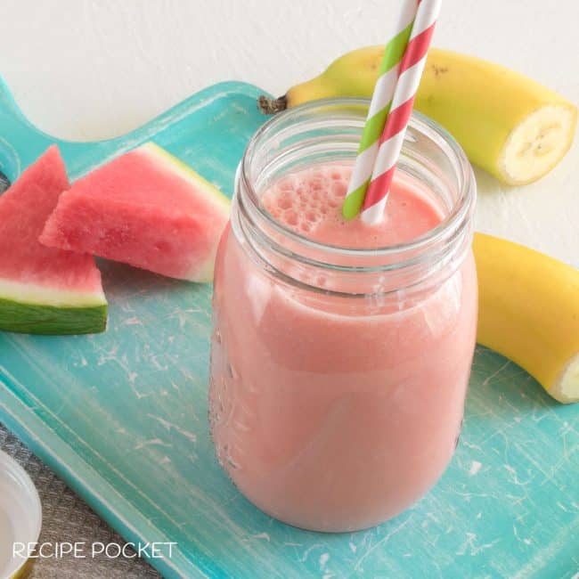 Watermelon banana smoothie on a green board.