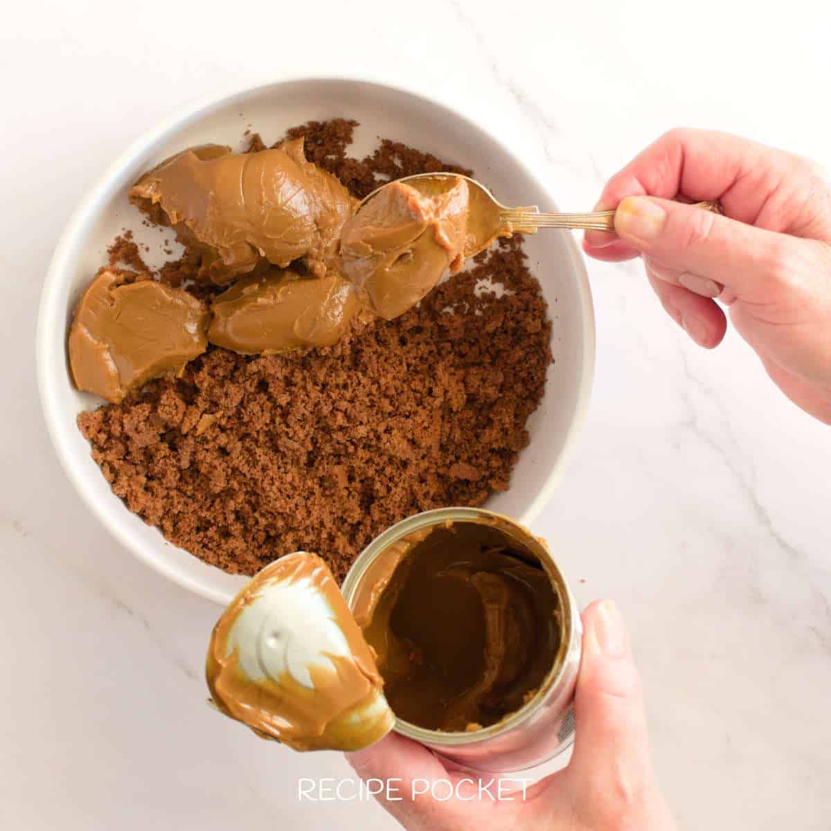 Caramel sauce and cake crumbs in a bowl.