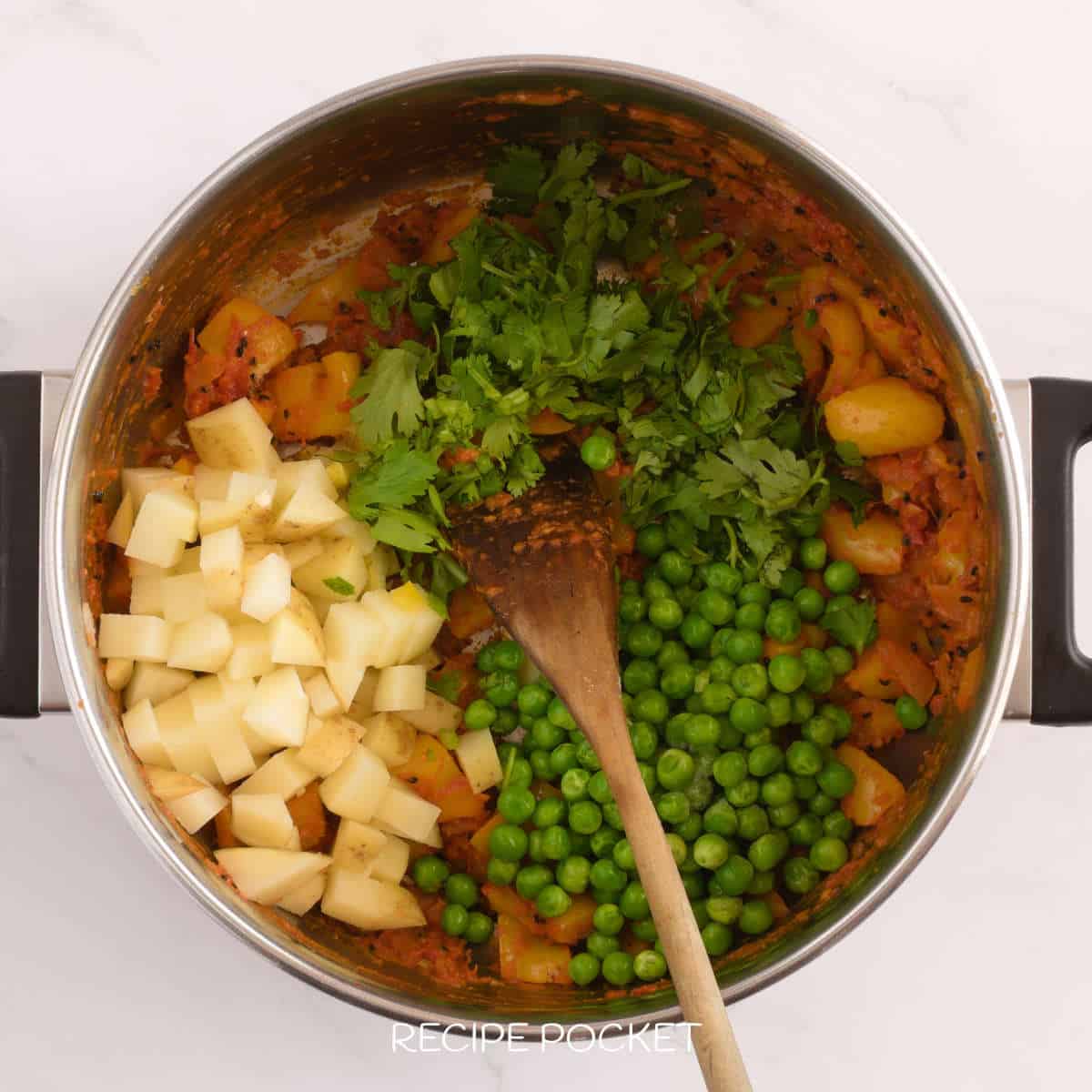 Potatoes, peas and coriander in a pot.