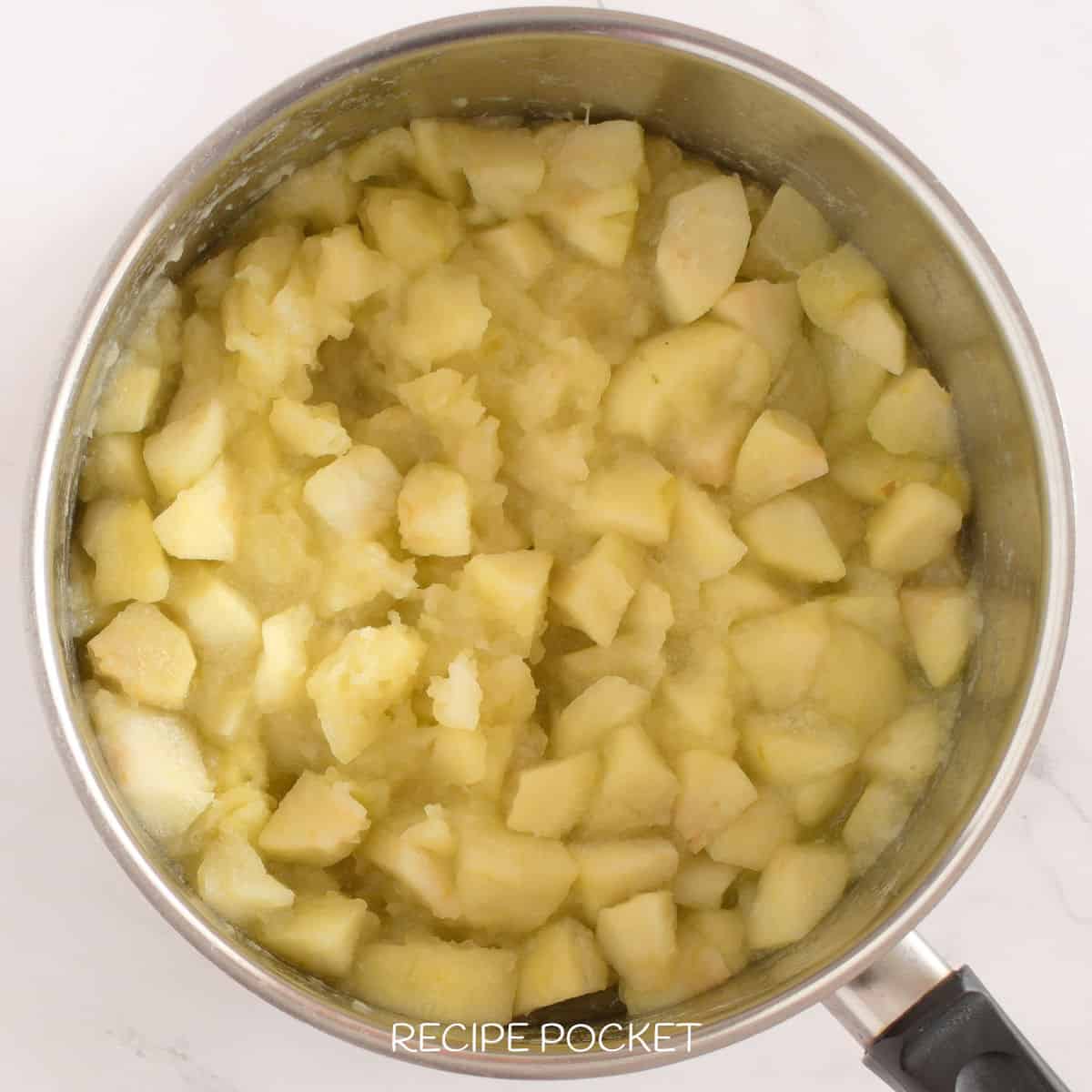 Cooked apple in a saucepan.