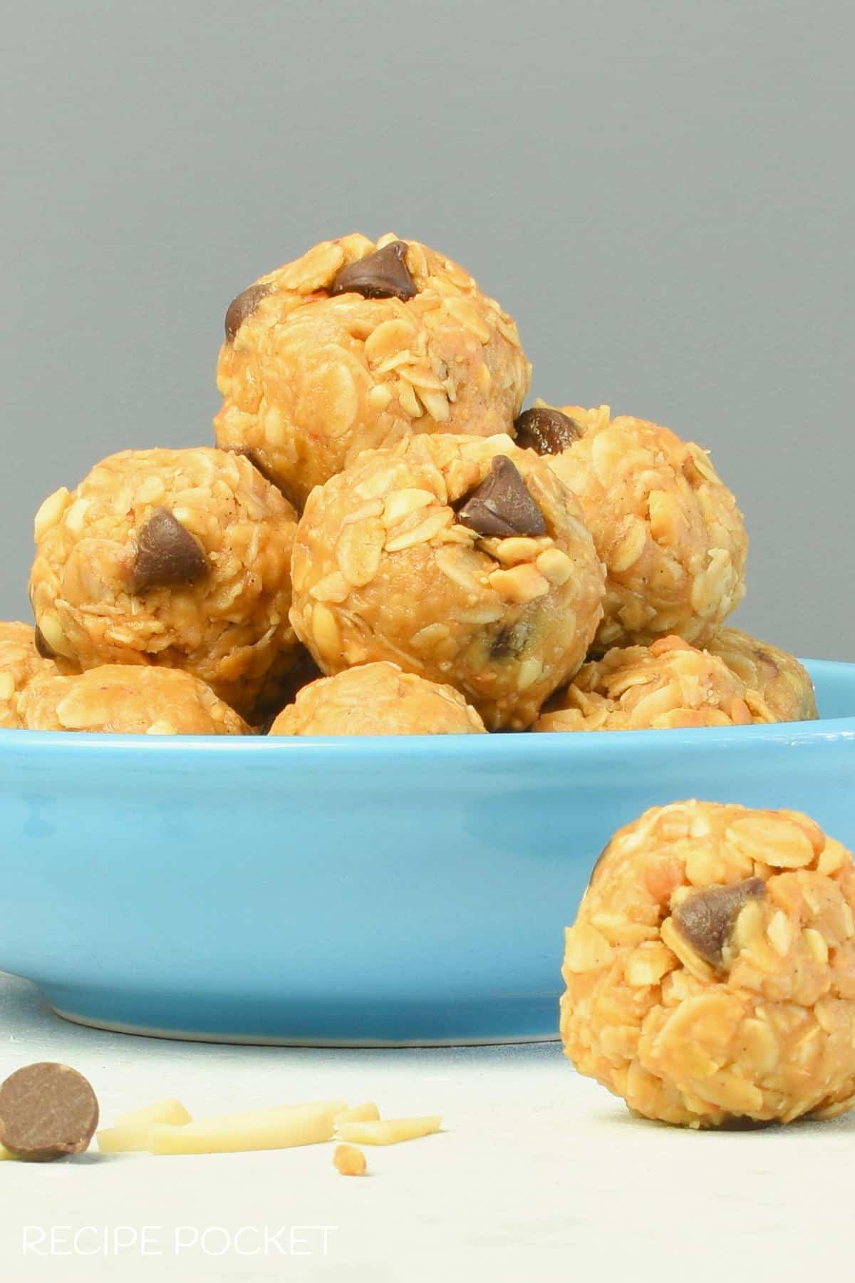 Closeup of no bake peanut butter oatmeal balls in a blue bowl.