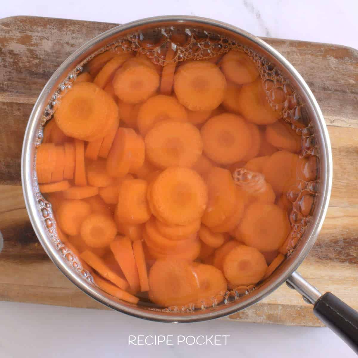Sliced carrots in a pot of water.