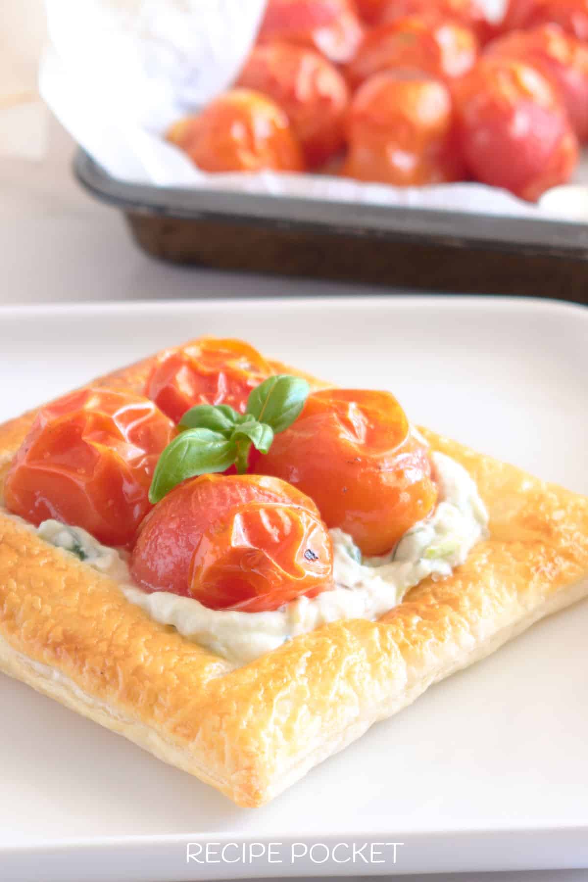 A close up of finished tomato puff pastry tartlet.