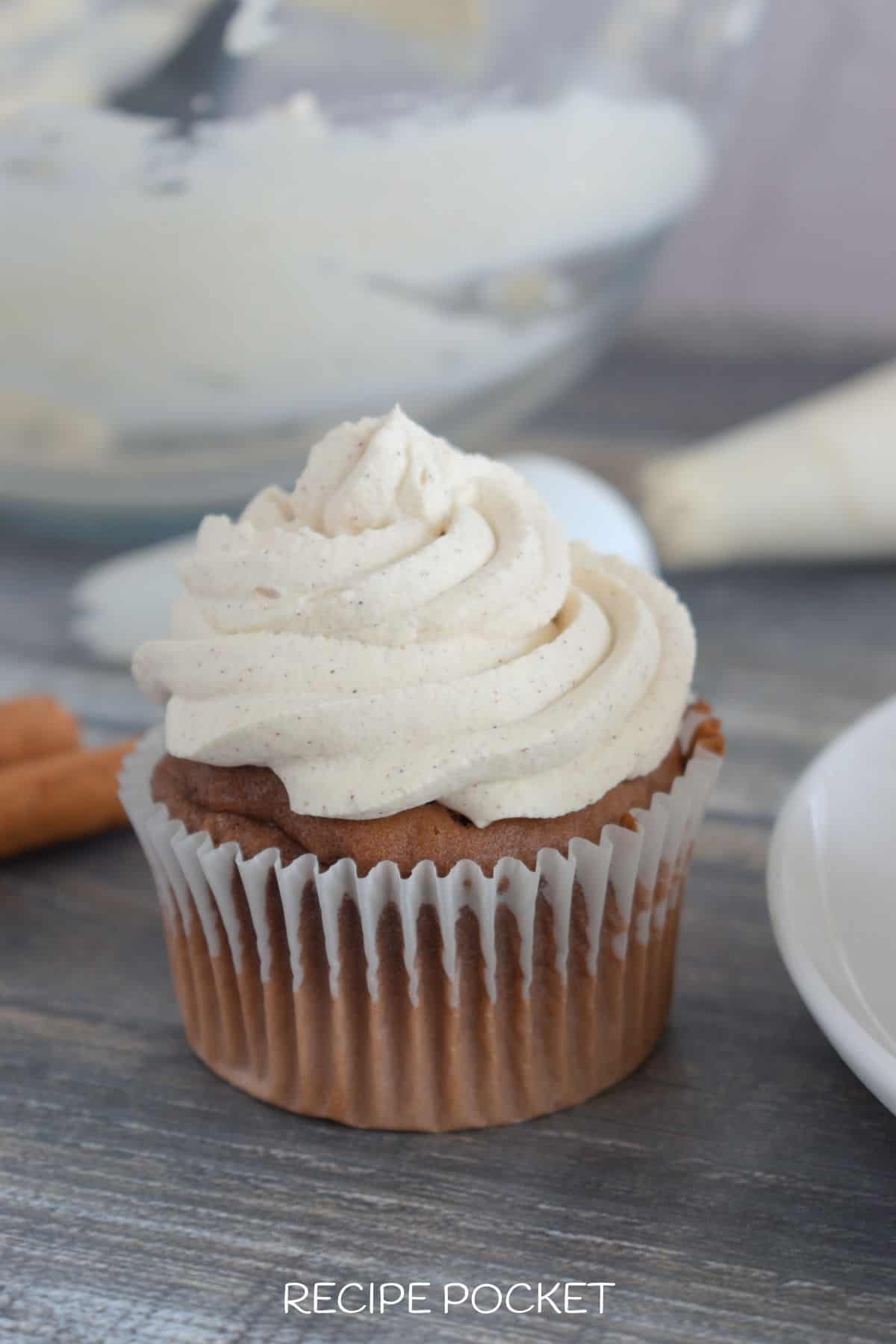 A cupcake with cream frosting.