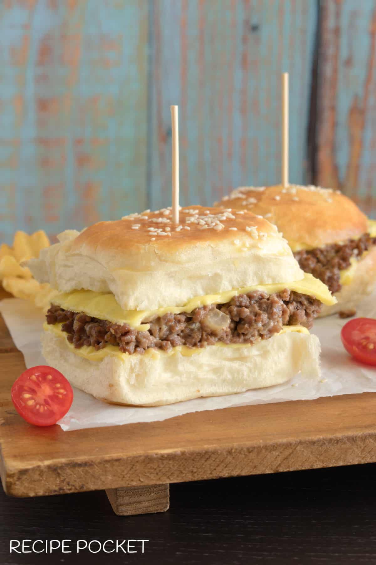Burgers with skewers in them.