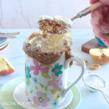 Apple mug cake being eaten with a fork.