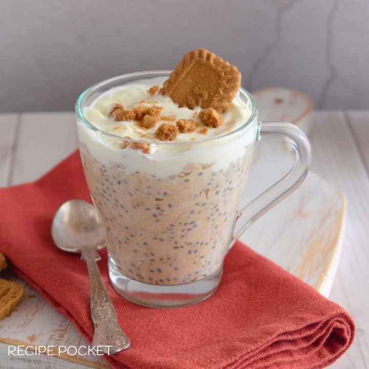 Biscoff overnight oats in a mug on a brown napkin.