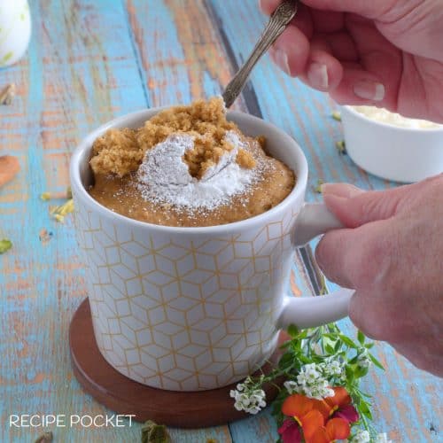 Gingerbread mug cake with fresh flowers in the table.
