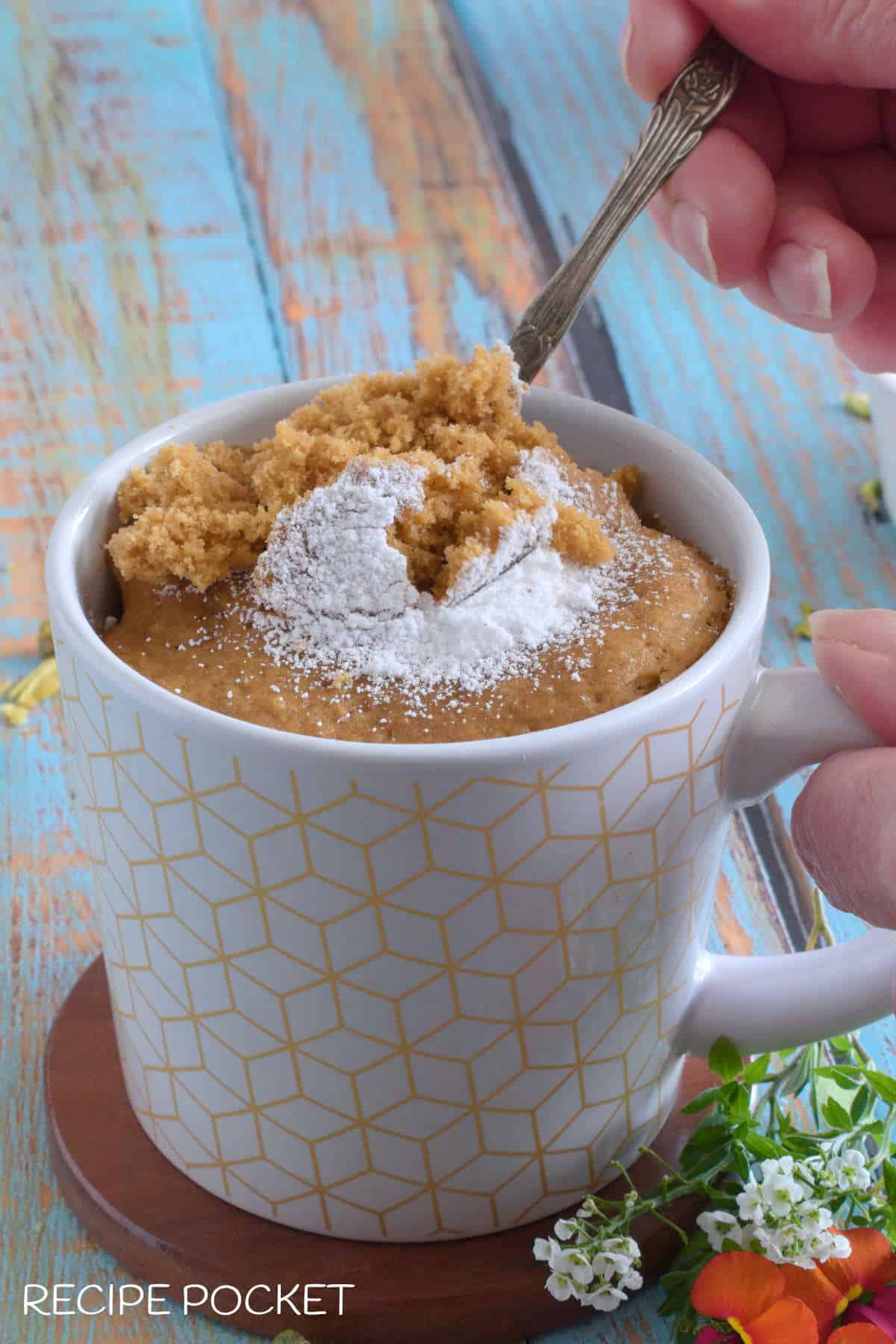 Gingerbread cake being scooped out of a mug.