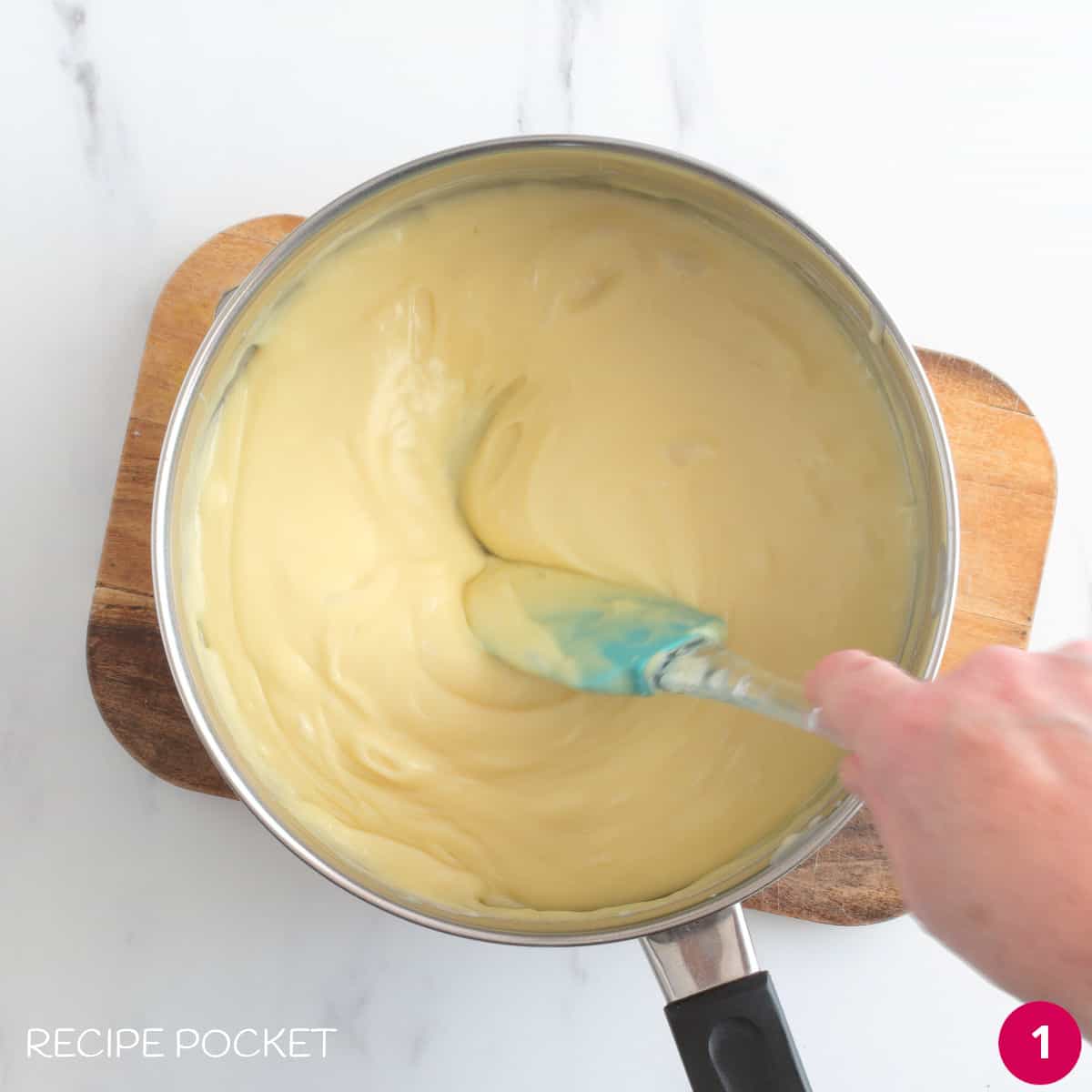 Melted white chocolate and condensed milk in a saucepan.