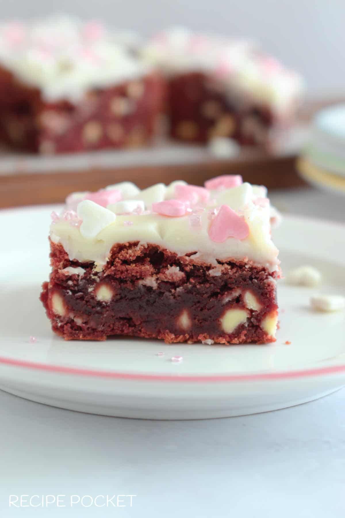 A red velvet brownie with white chocolate chips.