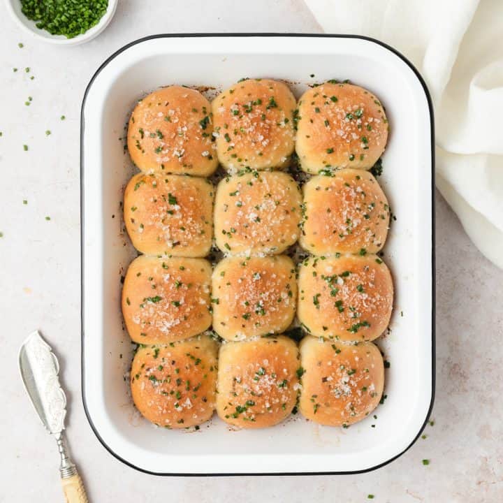 Sour cream and chives rolls in a white baking dish.