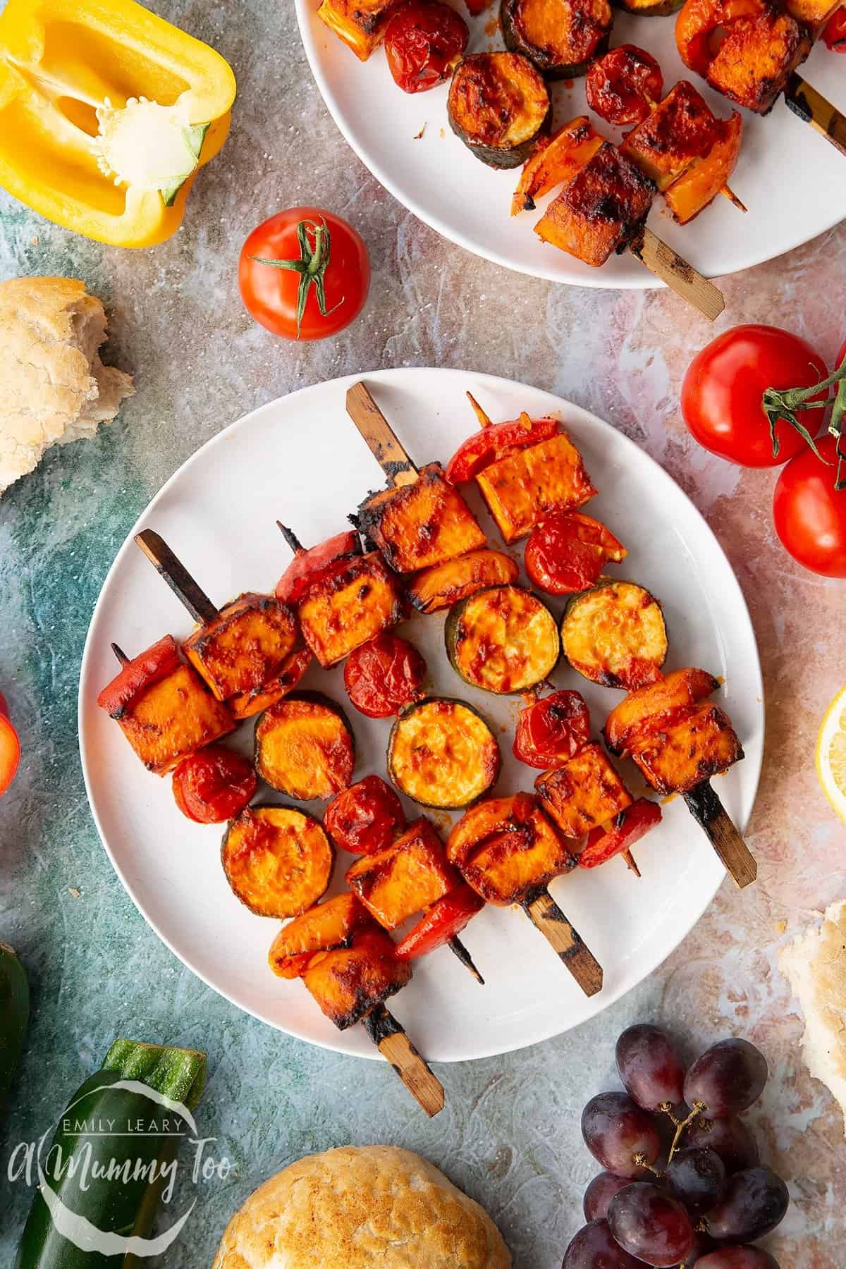 Tofu skewers on a white plate.