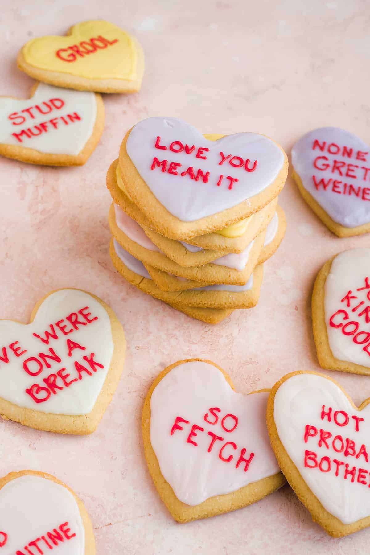 Conversation heart cookies with piped messages on them.