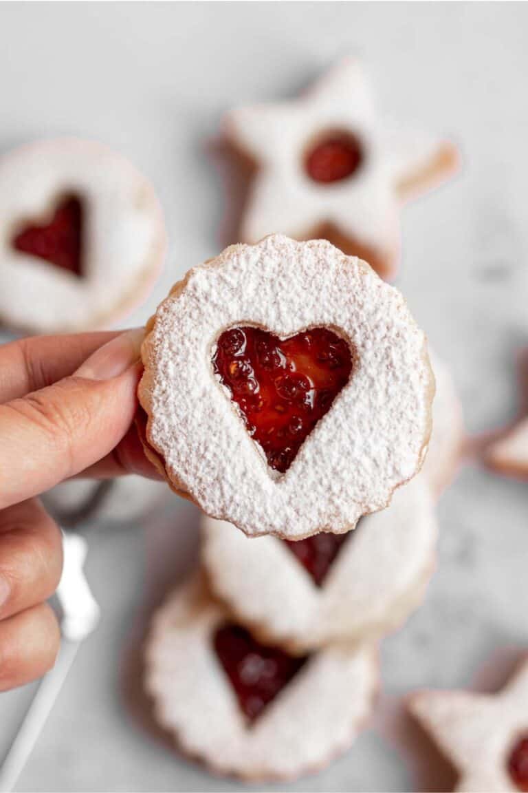 Linzer cookies with a powdered sugar coating.