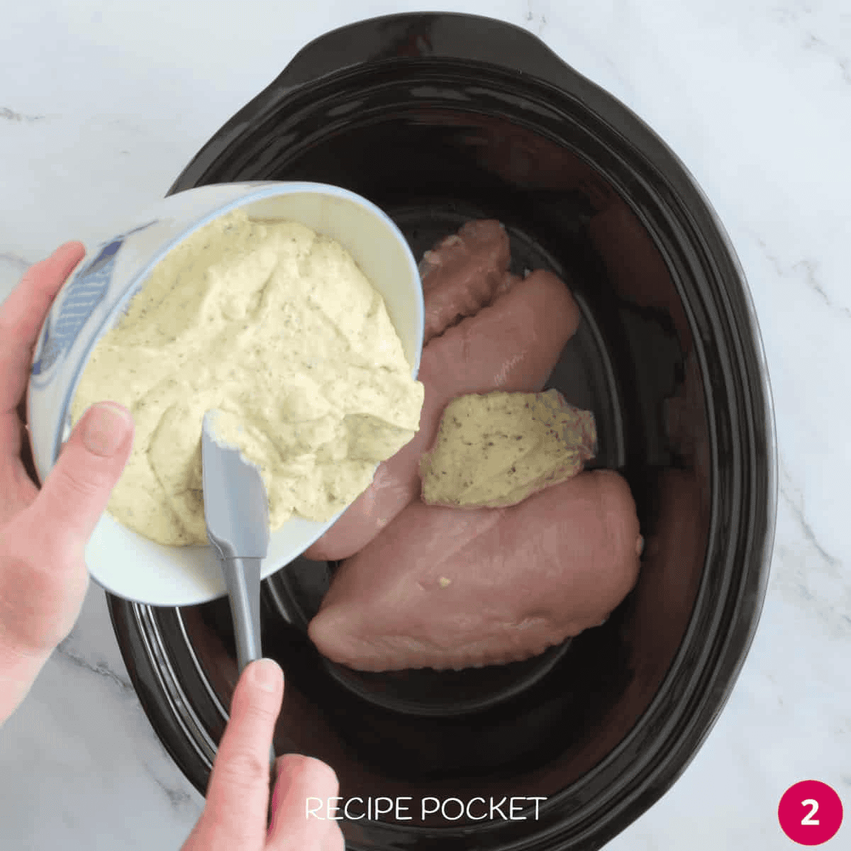 Garlic parmesan sauce being added to a slower cooker bowl.