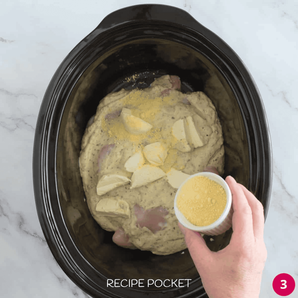 Ingredients for slow cooker parmesan chicken in a slow cooker.