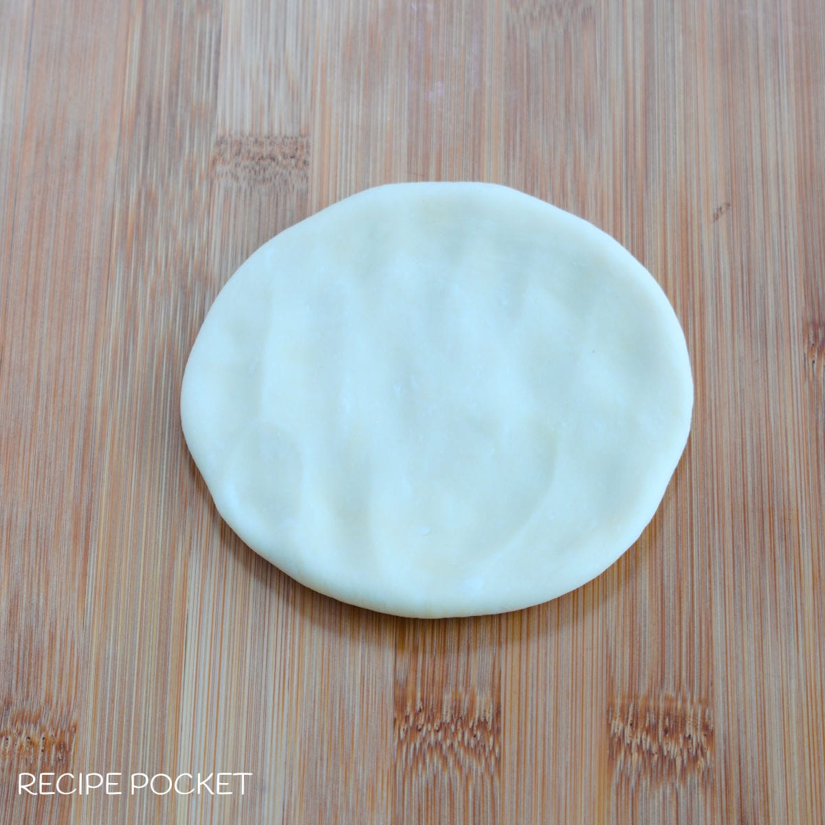 Dough flattened into a circle.