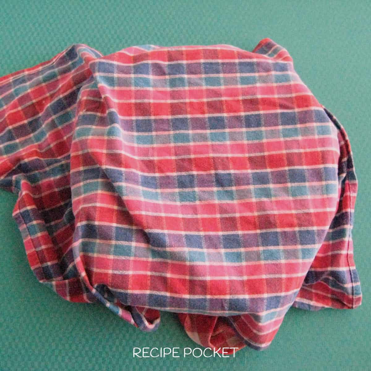 Tea towel covering a bowl.